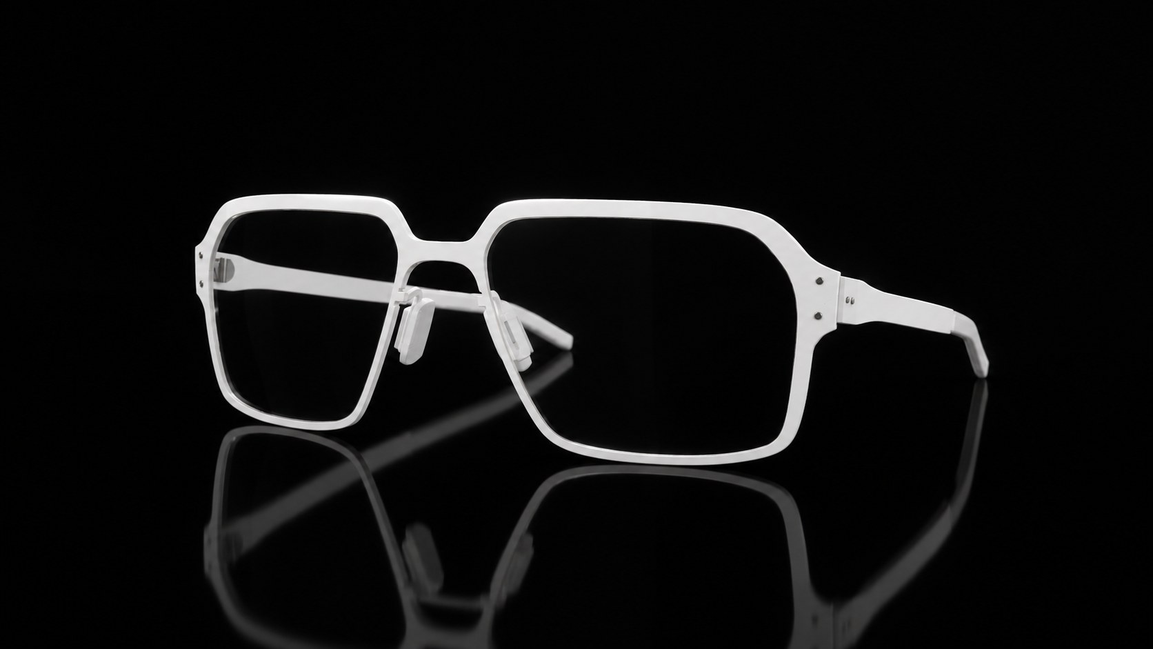 White titanium Canyon frame on a black reflective surface