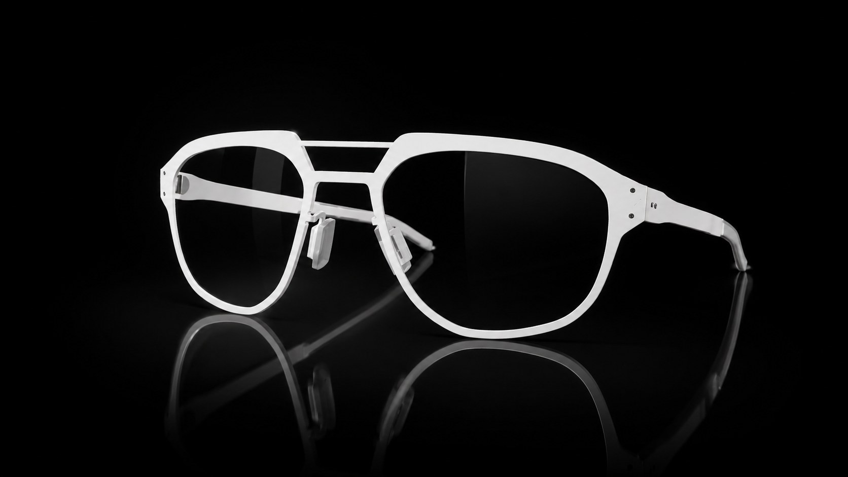 White titanium Osprey frame on a black reflective surface